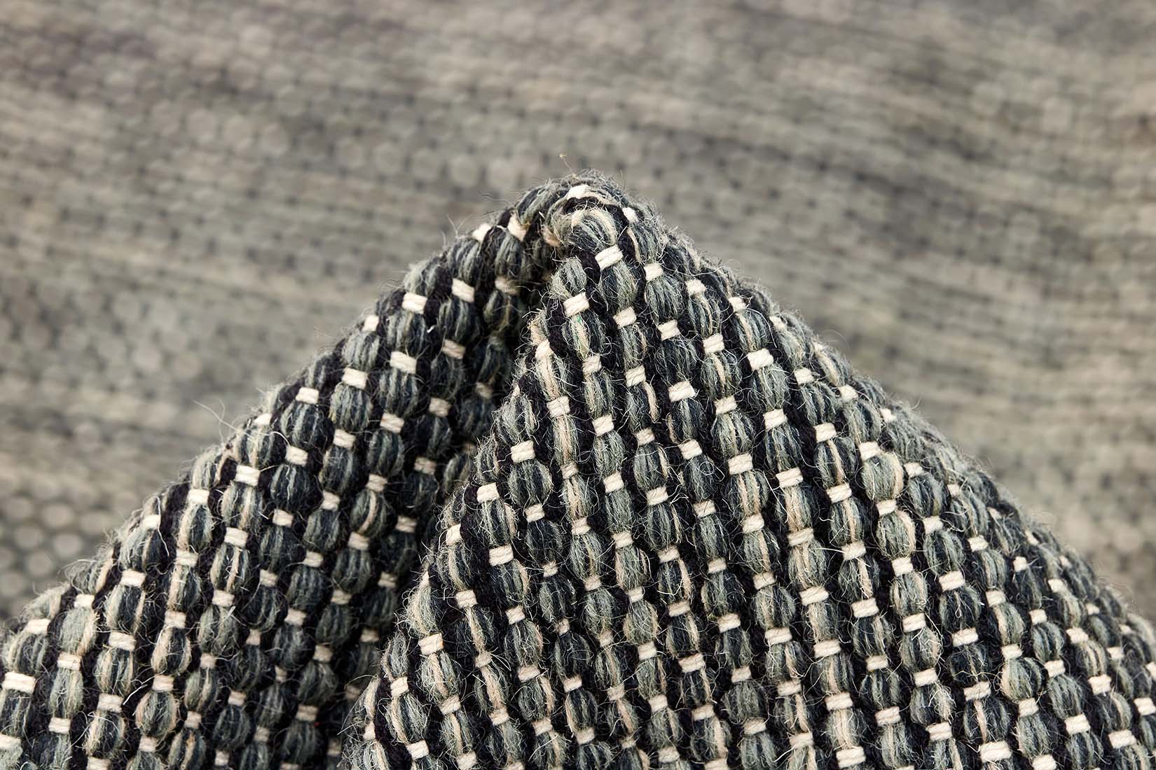 plain black and green flatweave wool rug