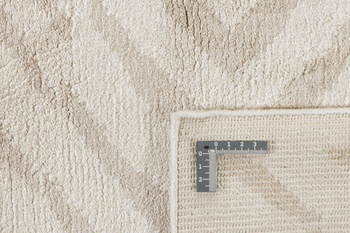 beige rug with a geometric pattern