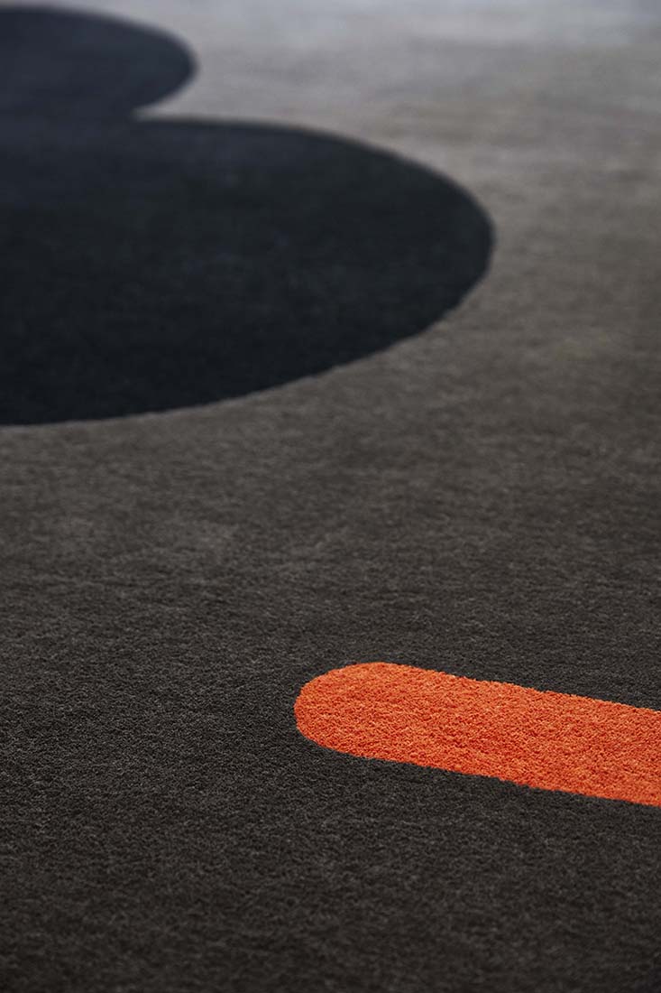 grey and black wool rug with retro floral design