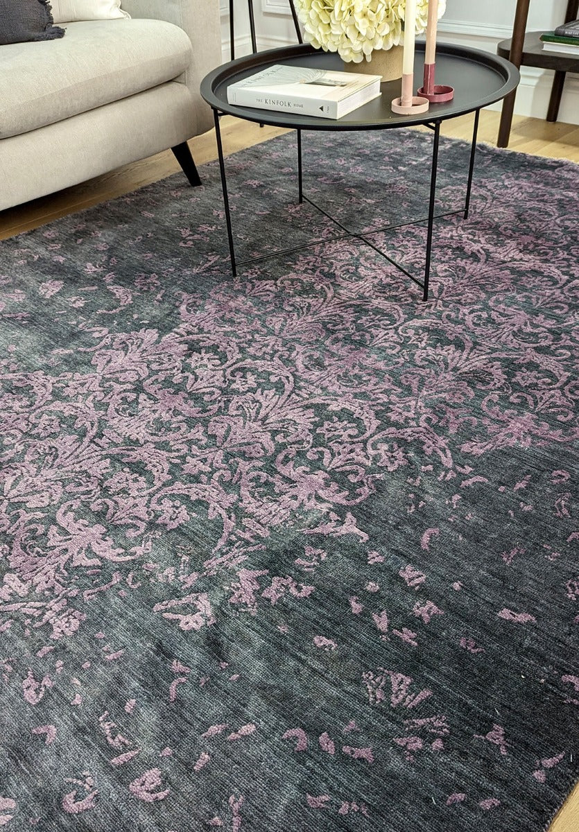Authentic oriental rug with a damask pattern in black and purple