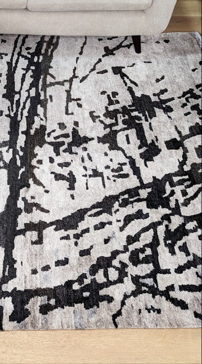 oriental rug with an abstract traditional pattern in grey