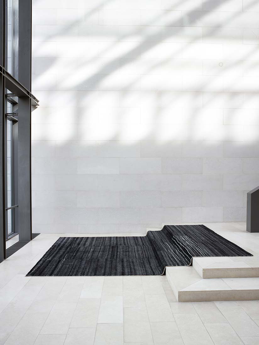 dark grey area rug with abstract design