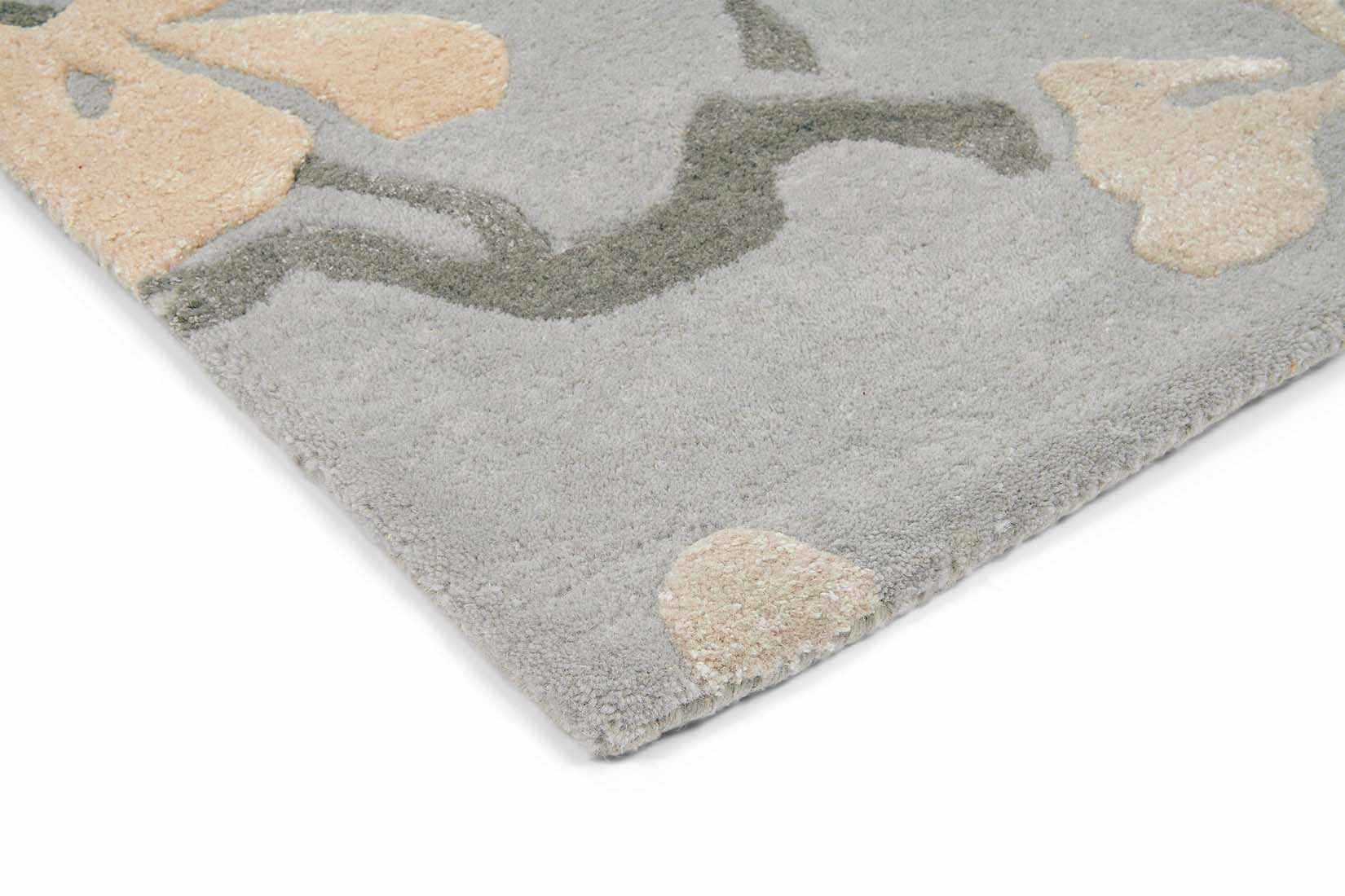 Rectangular blue rug with dark blue branch design and white flowers and leaves