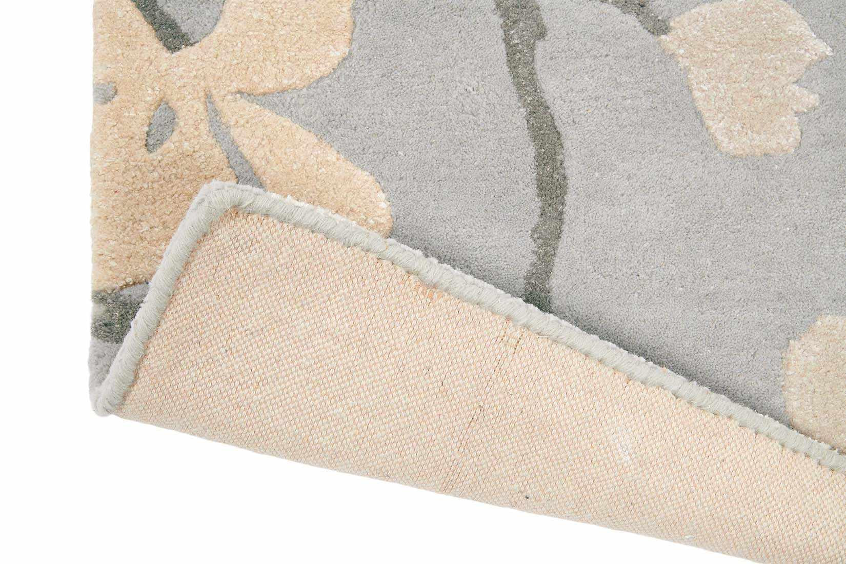 Rectangular blue rug with dark blue branch design and white flowers and leaves