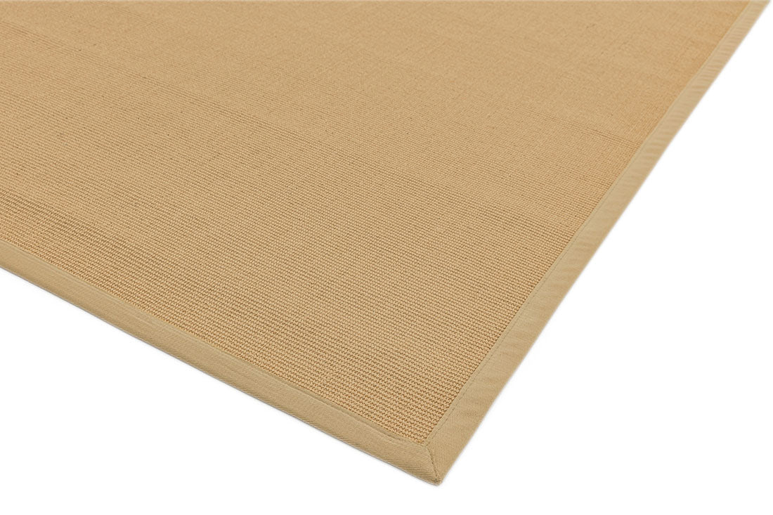 beige sisal rug with a beige border