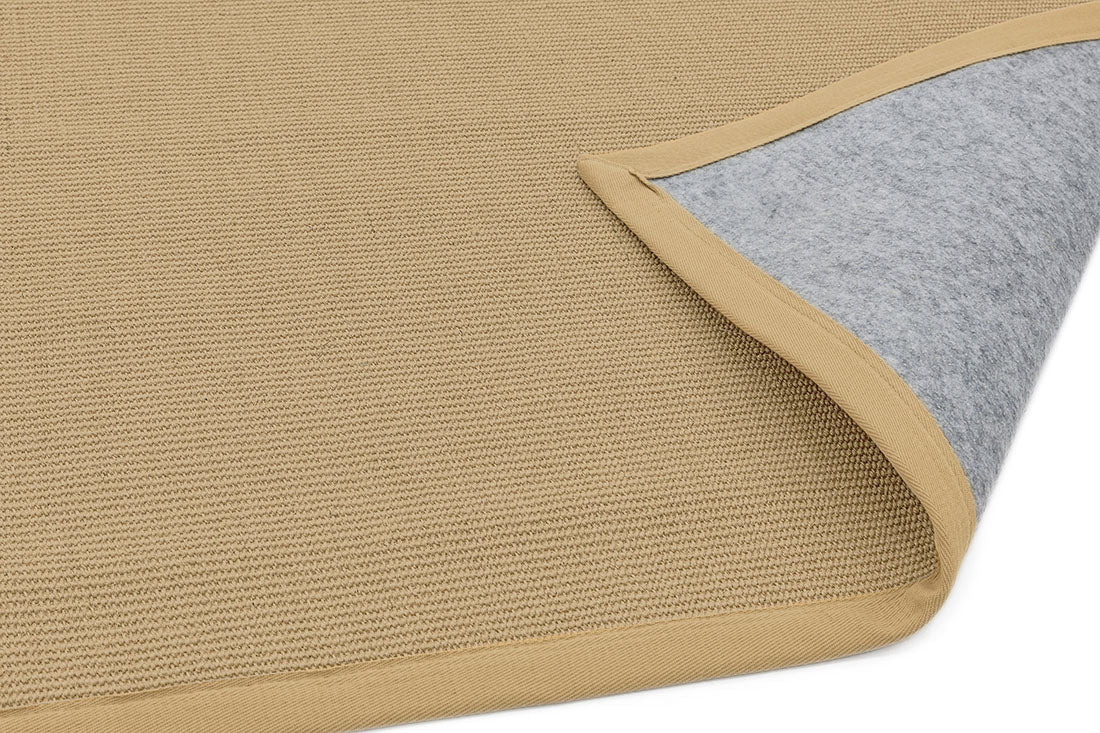 beige sisal rug with a beige border