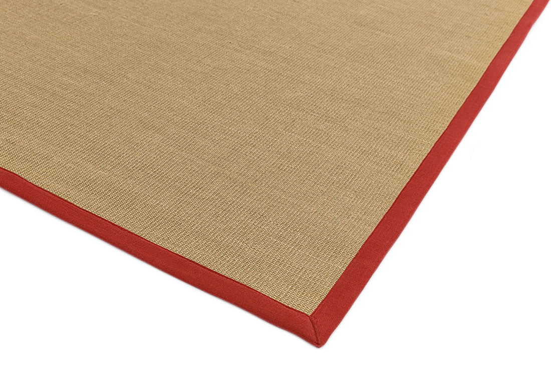 beige sisal rug with a red border