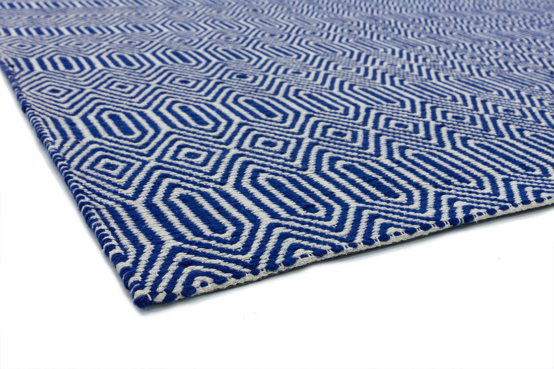 blue and white woven rug with aztec chevron pattern