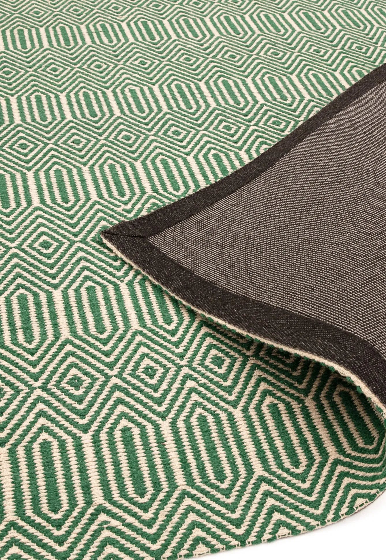 Green woven rug with aztec chevron pattern