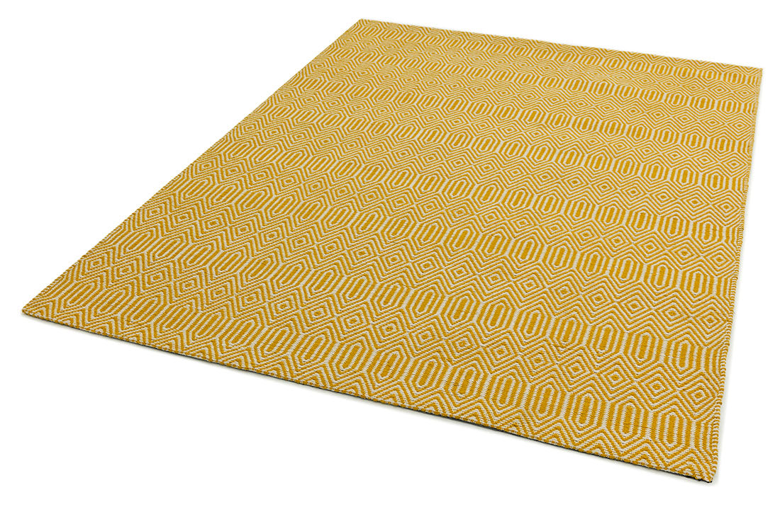 mustard yellow and white rug with a geometric aztec pattern