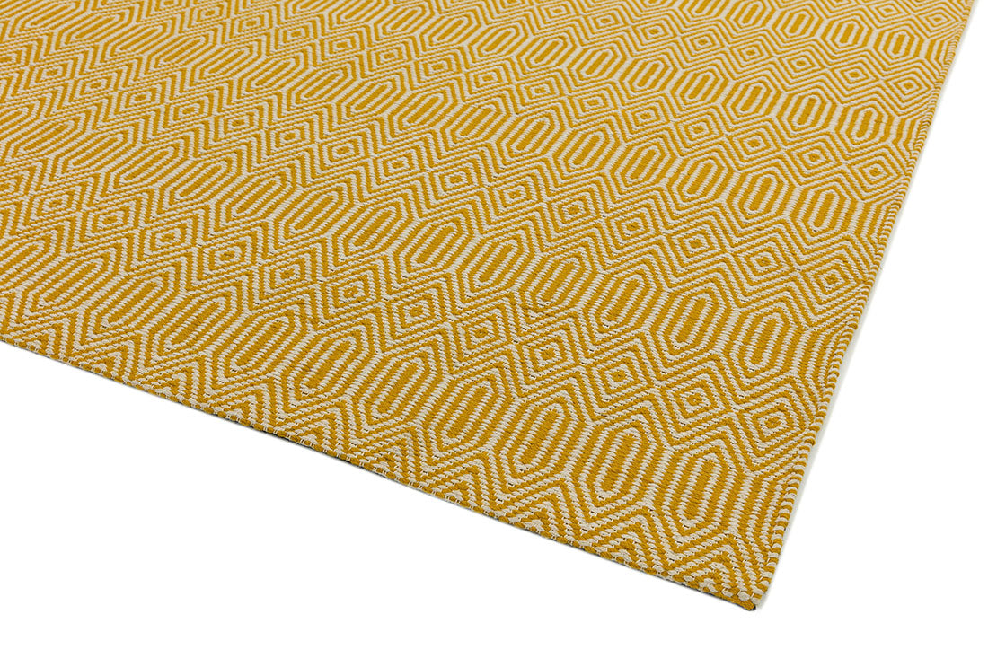 mustard yellow and white rug with a geometric aztec pattern