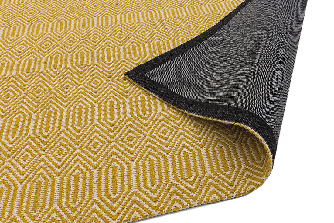 mustard yellow and white rug with a geometric aztec pattern