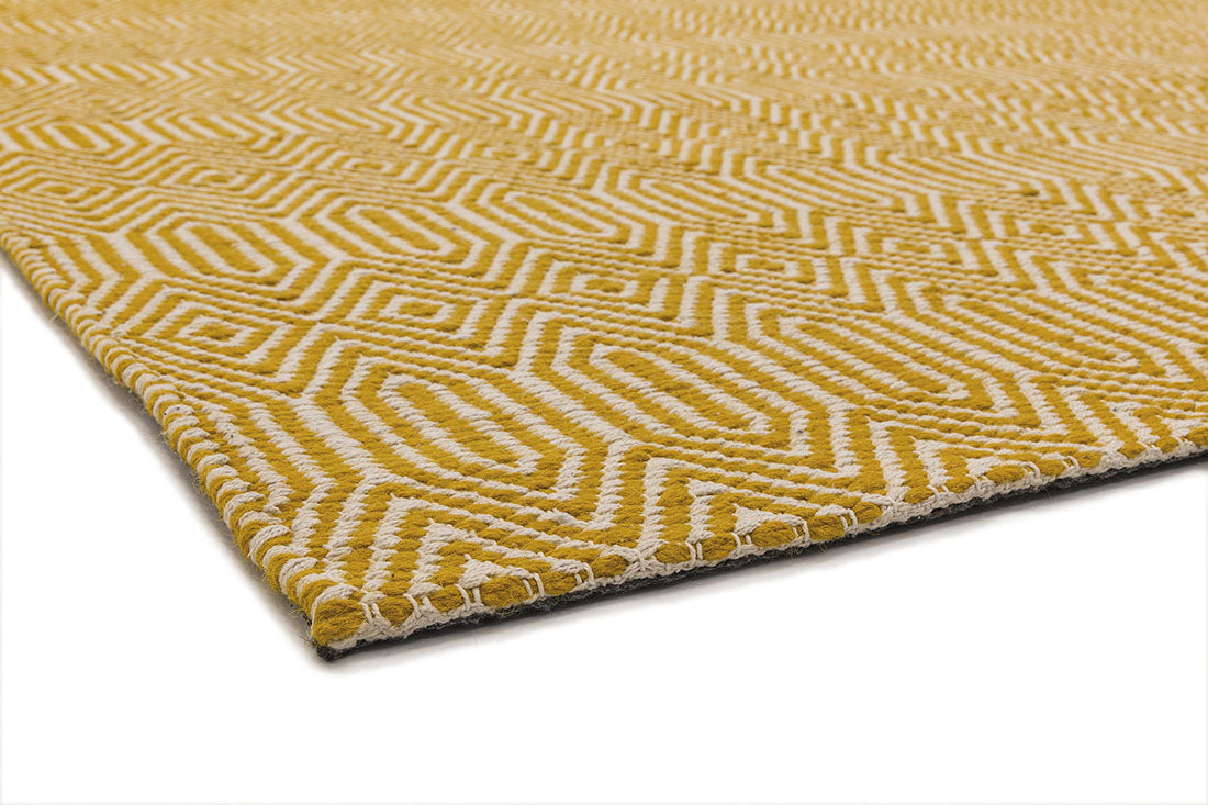 mustard yellow and white rug with a geometric aztec pattern