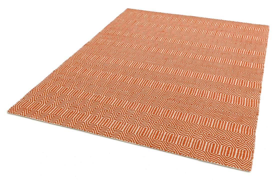 orange and white woven rug with aztec chevron pattern