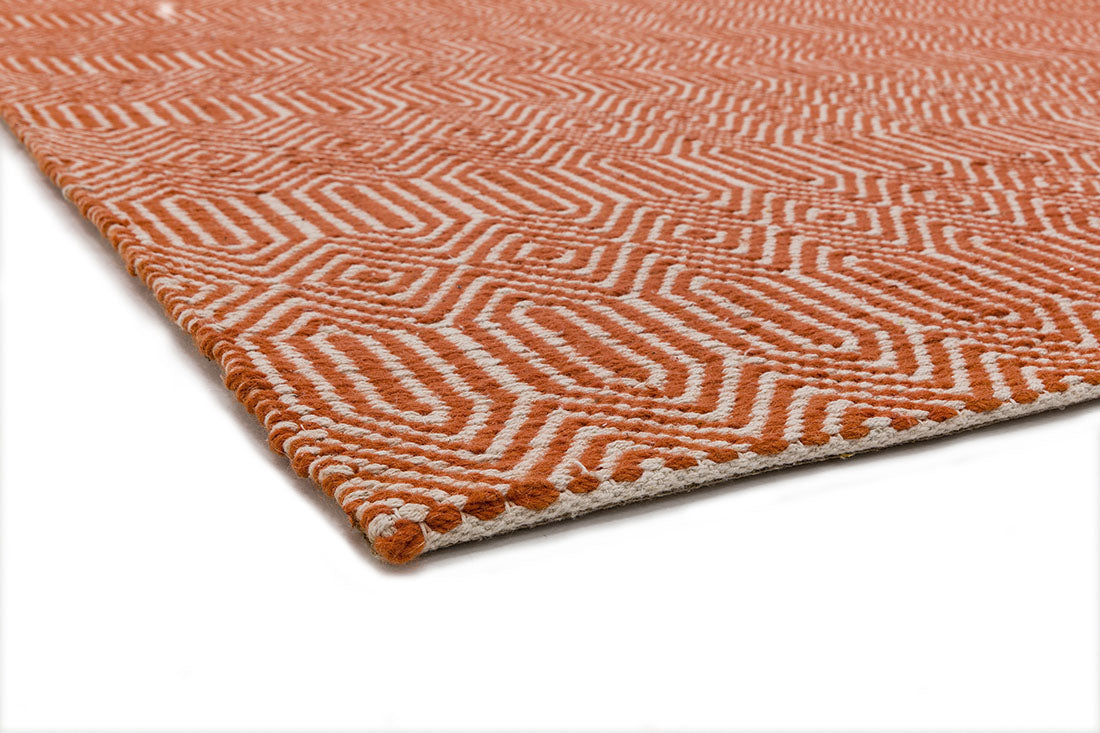 orange and white woven rug with aztec chevron pattern