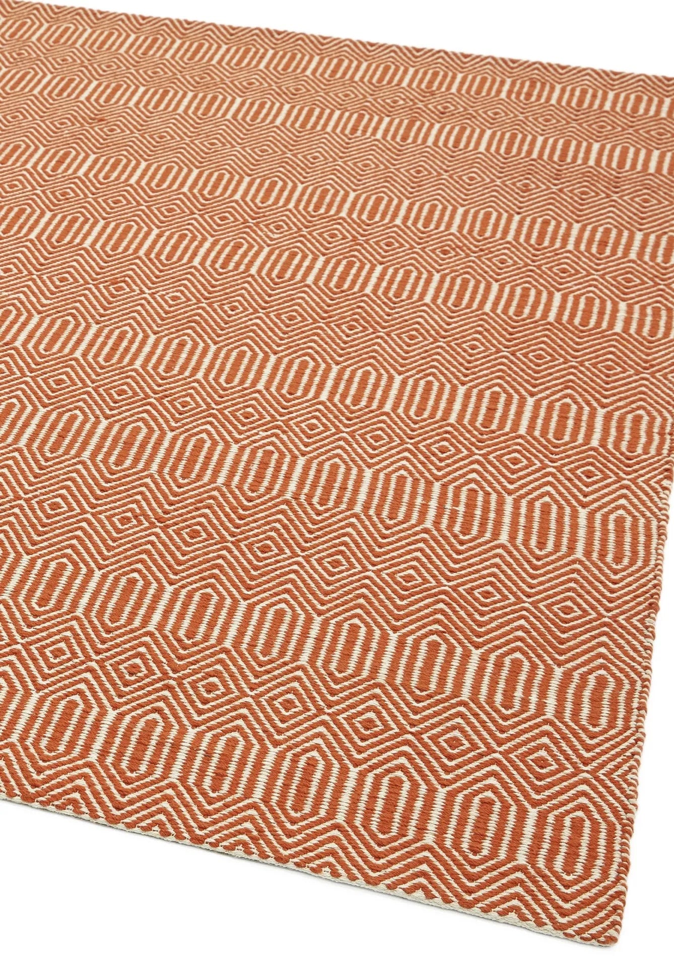 orange and white geometric runner with an aztec pattern