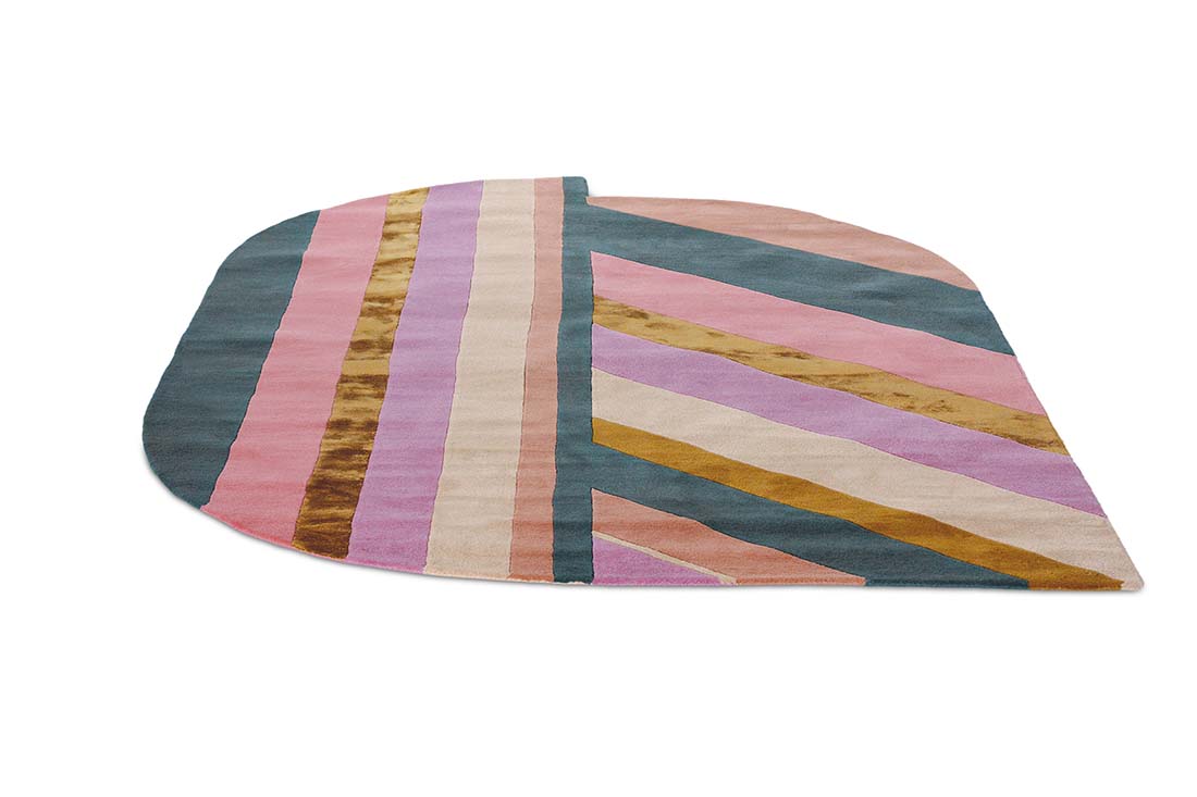 Striped pink, teal and gold rug in an abstract shape
