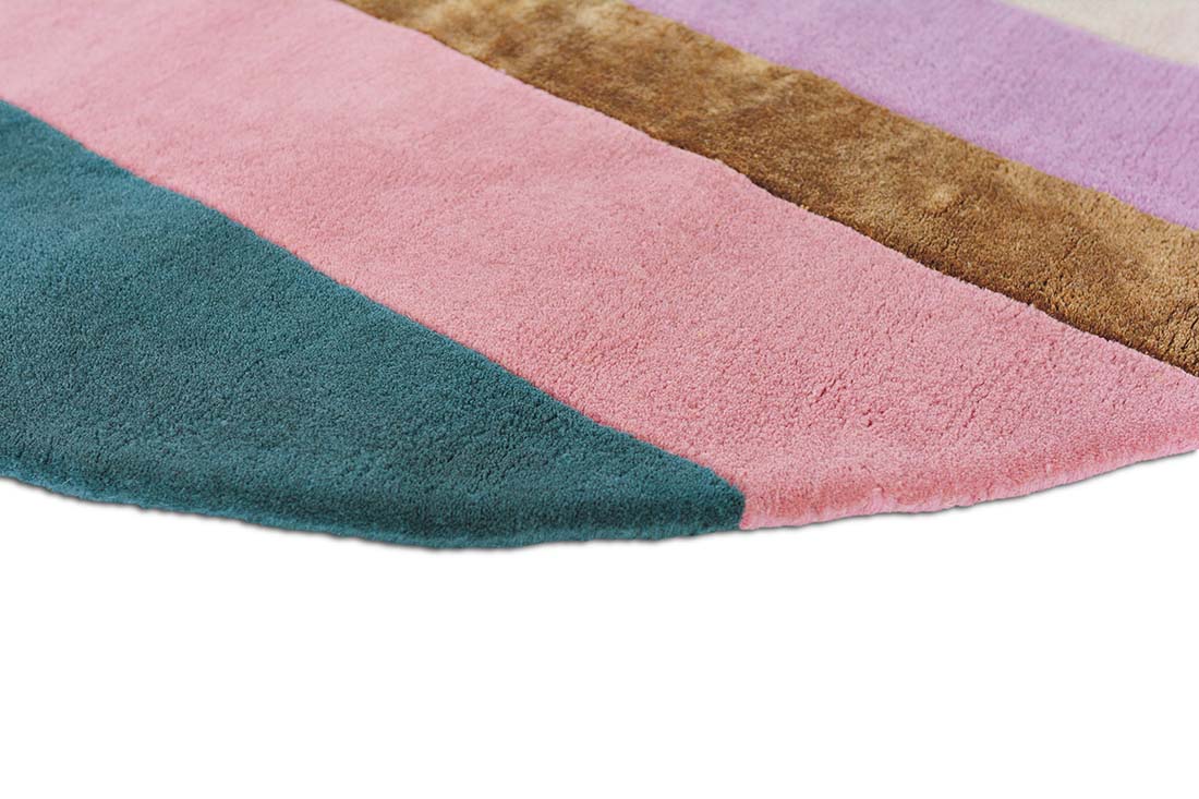 Striped pink, teal and gold rug in an abstract shape