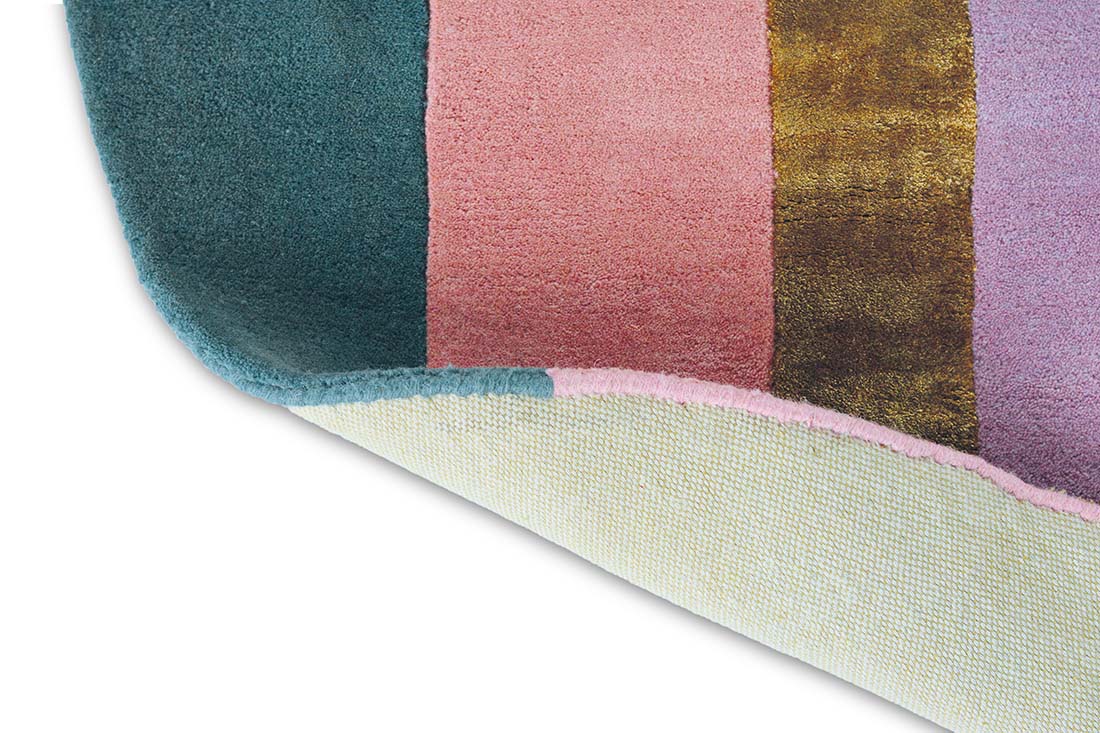 Striped pink, teal and gold rug in an abstract shape