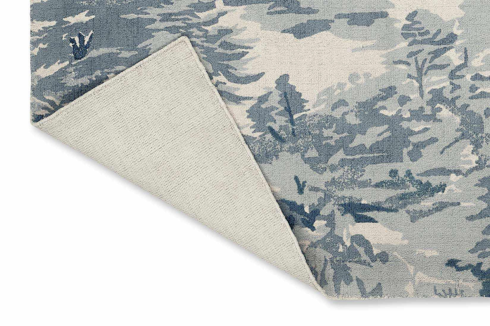 cream cotton rug with tree pattern in blue