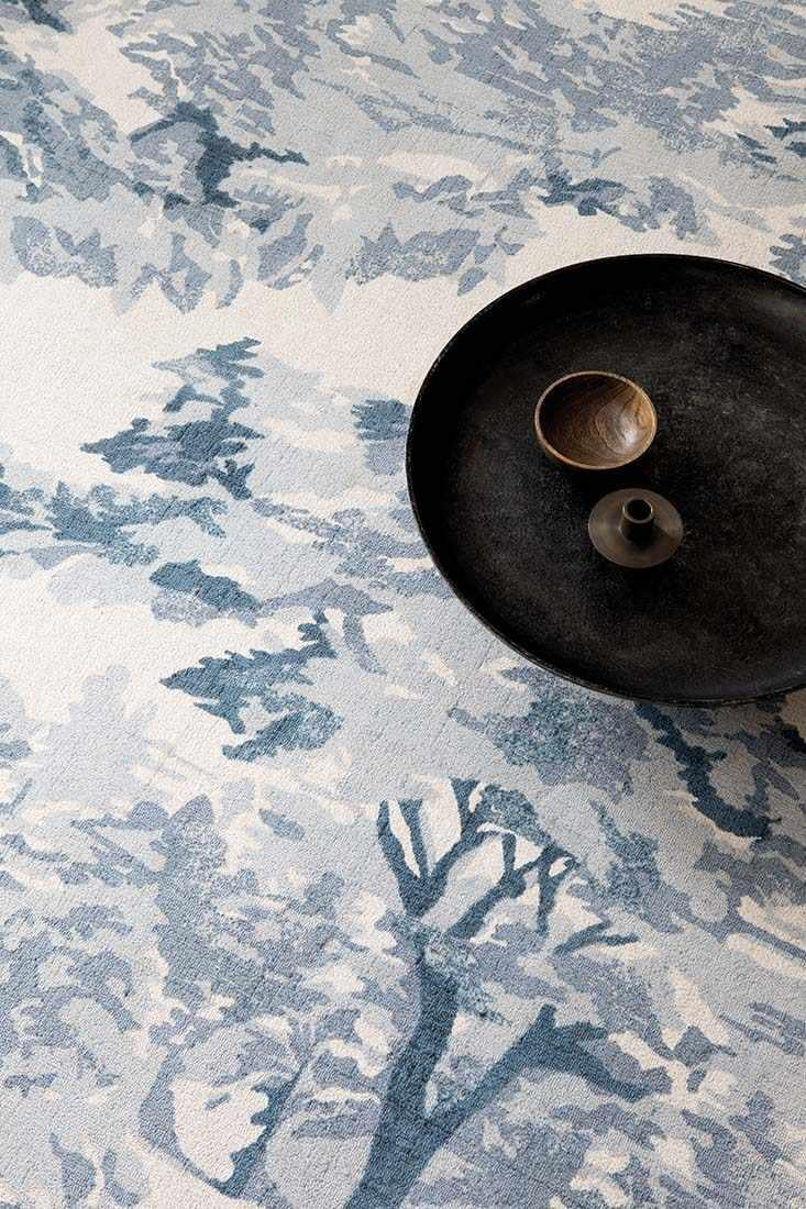 cream cotton rug with tree pattern in blue
