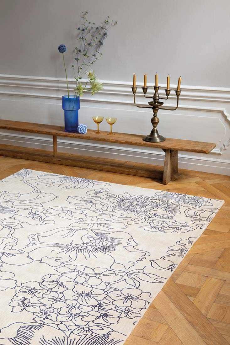 cream cotton rug with floral pattern in blue