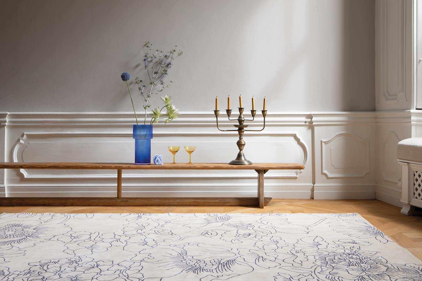 cream cotton rug with floral pattern in blue