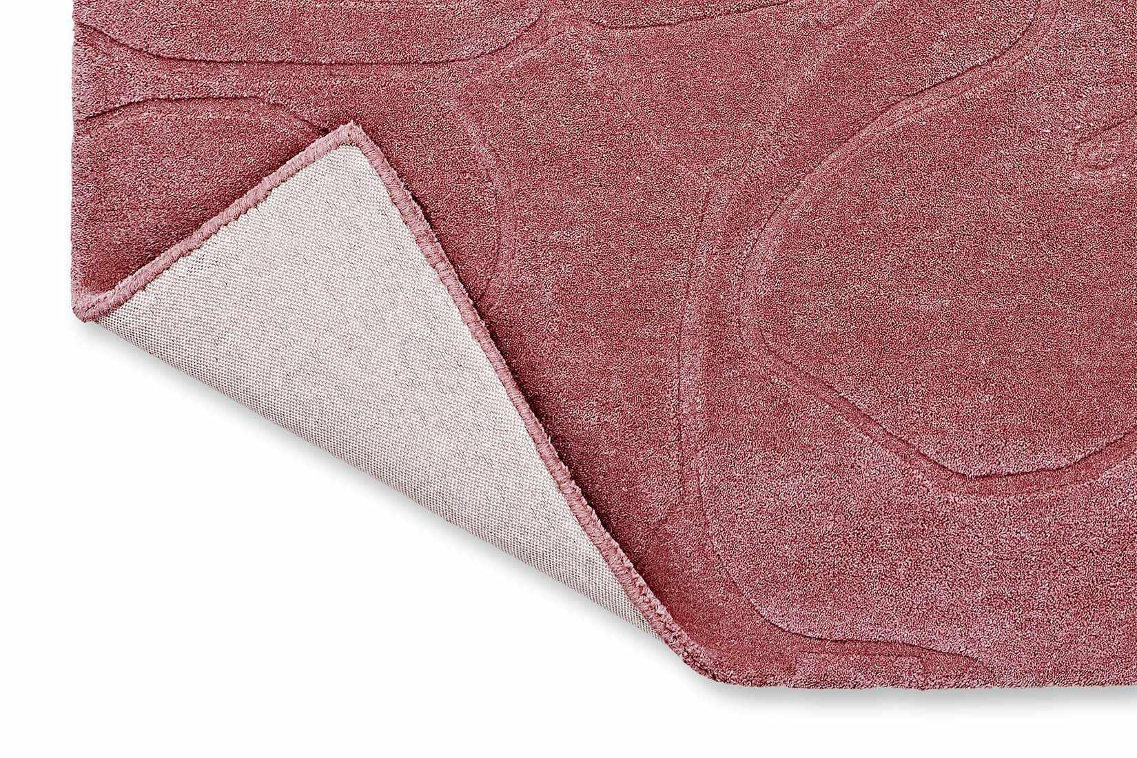 pink wool rug with floral shapes
