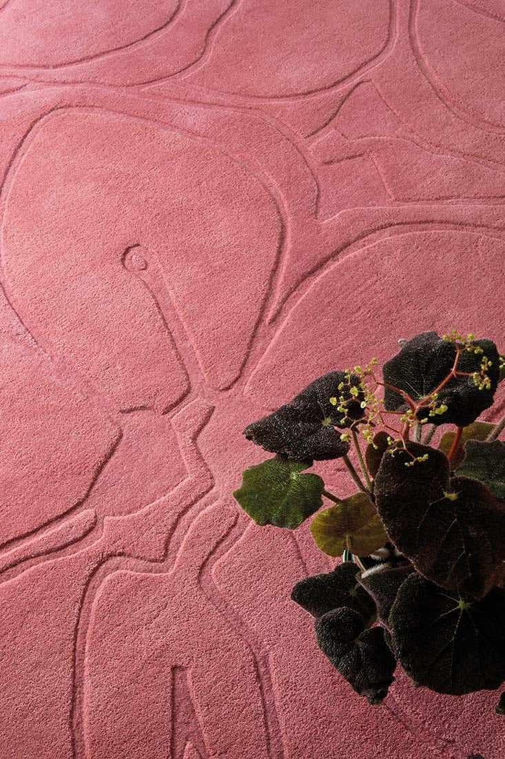 pink wool rug with floral shapes