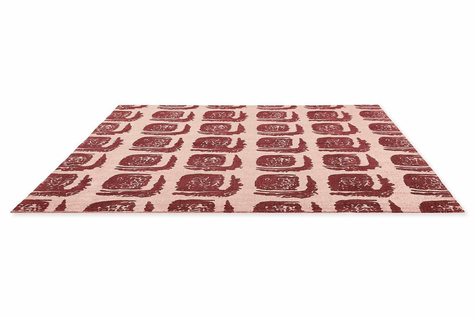 pink cotton rug with abstract red squares