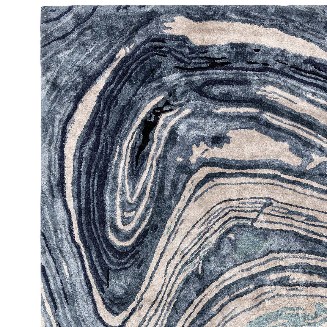 shiny blue and beige handtufted abstract rug in a marble design
