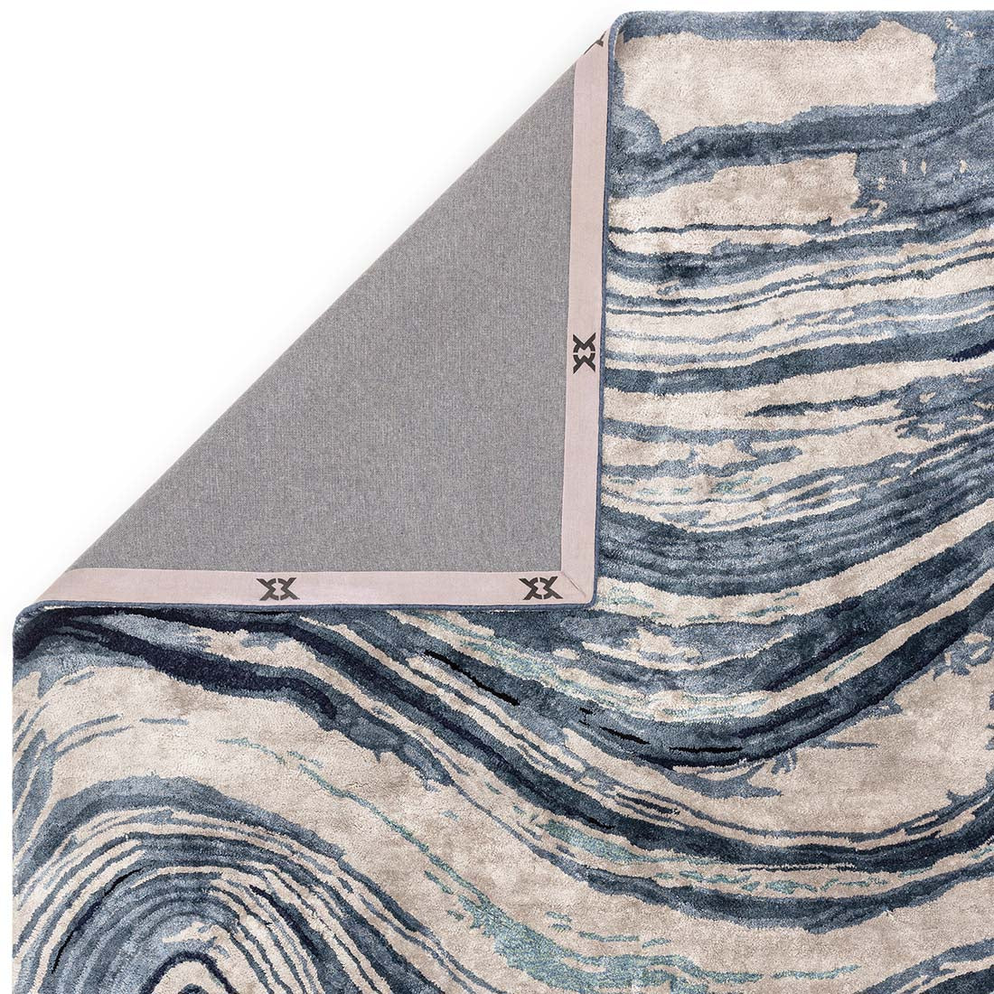 shiny blue and beige handtufted abstract rug in a marble design