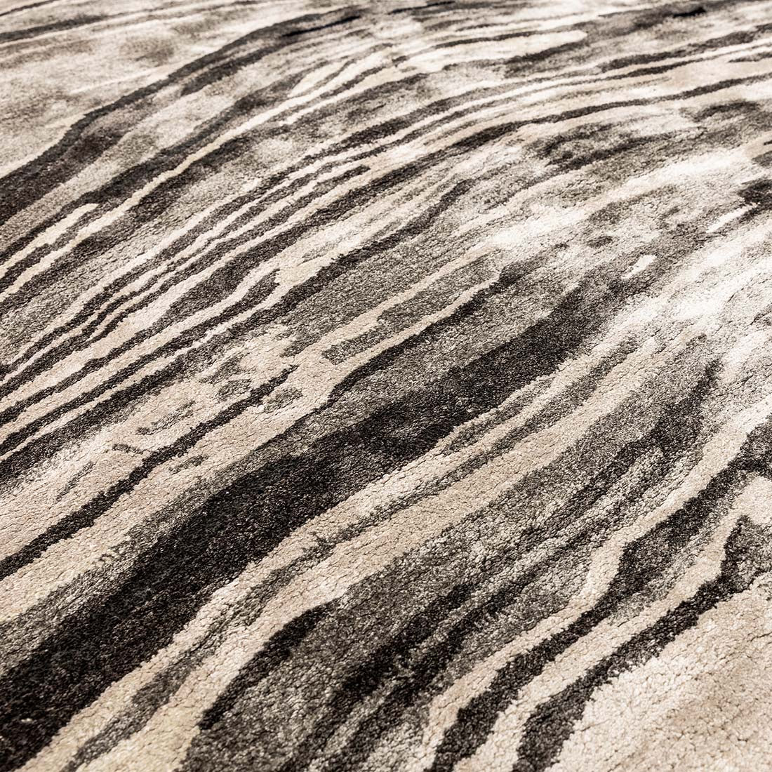 black and beige handtufted abstract rug in a marble design