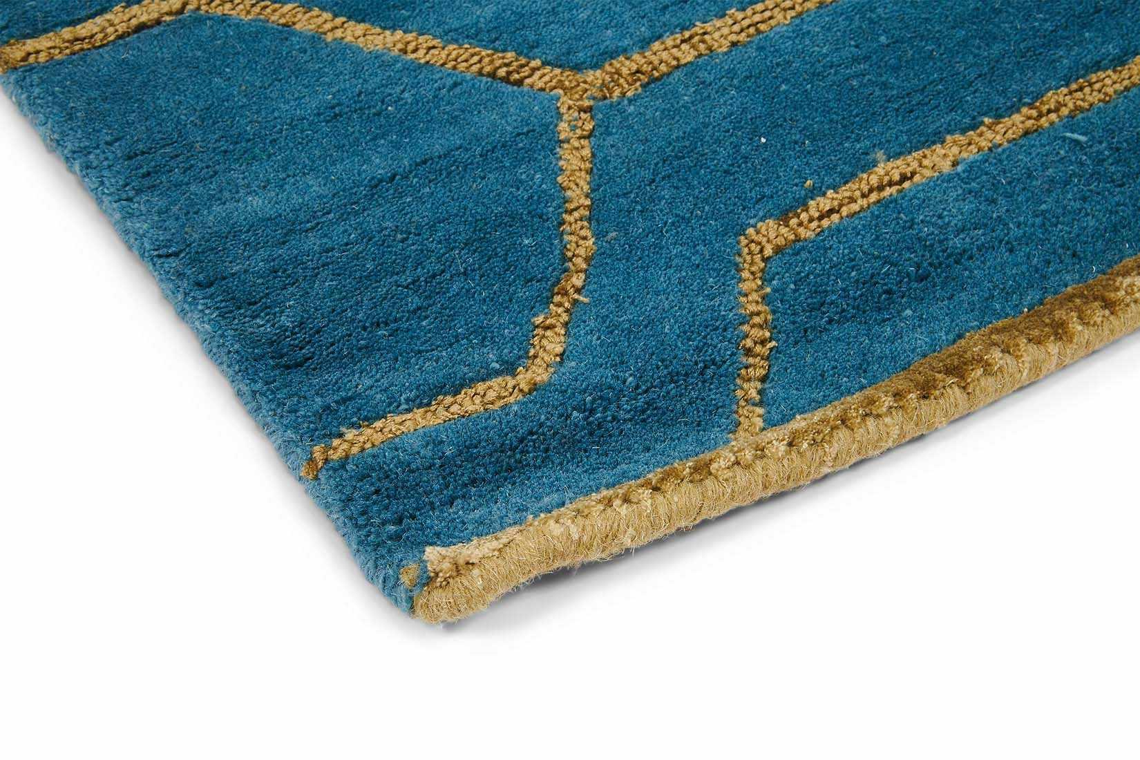 Rectangular teal green rug with repeat gold hexagon pattern