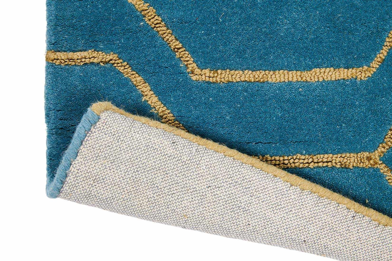 Rectangular teal green rug with repeat gold hexagon pattern