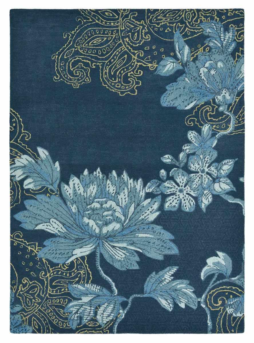 Rectangular navy blue rug with blue floral design, gold paisley pattern and engraved shapes