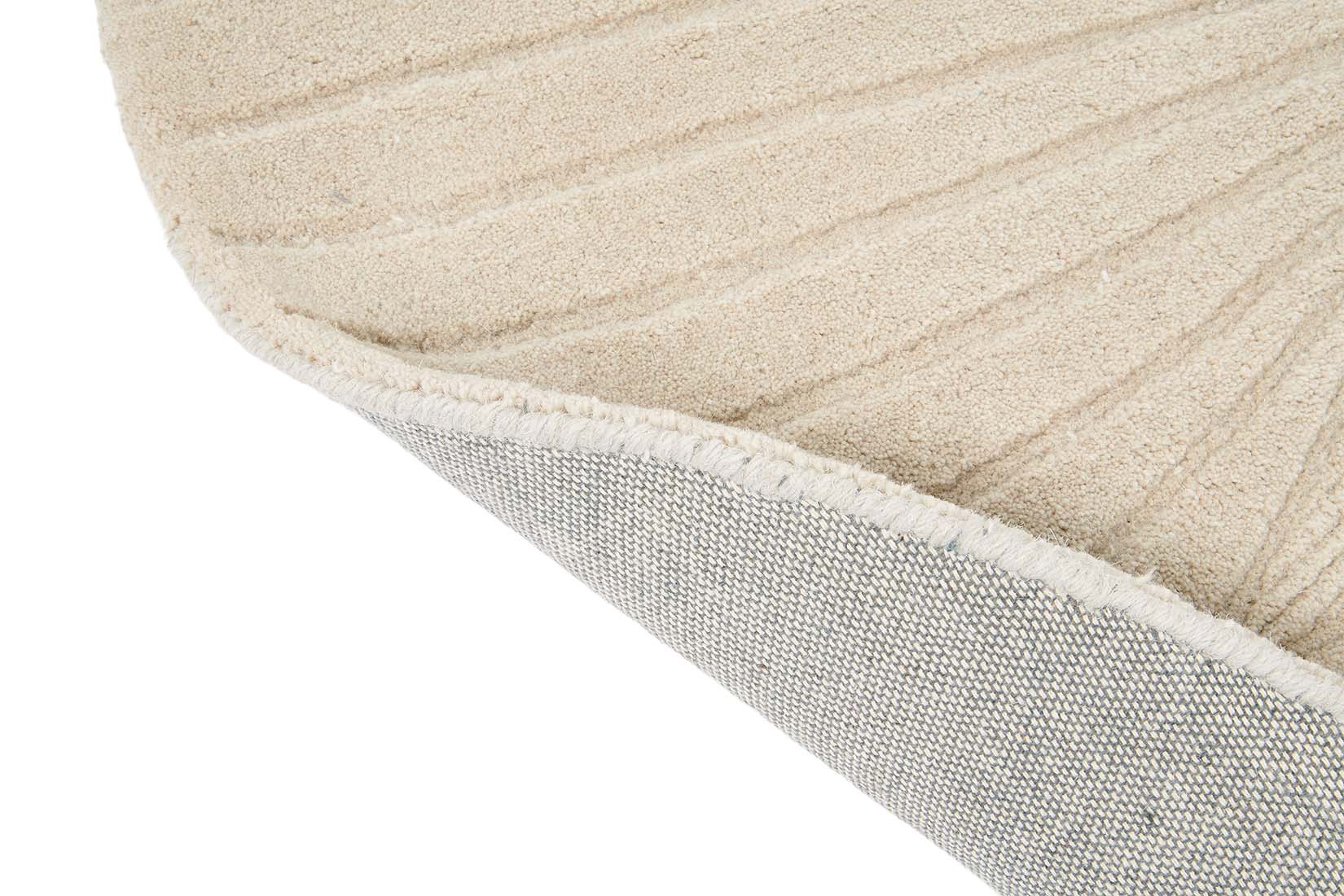 Round beige rug with engraved floral botanical pattern