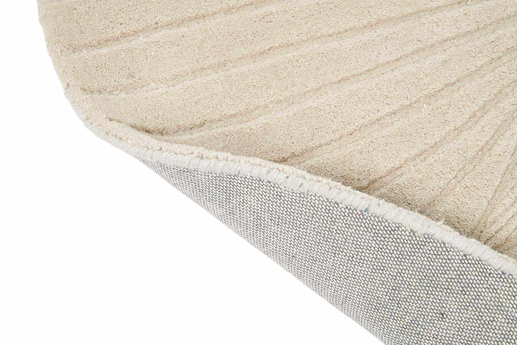 Round beige rug with engraved floral botanical pattern