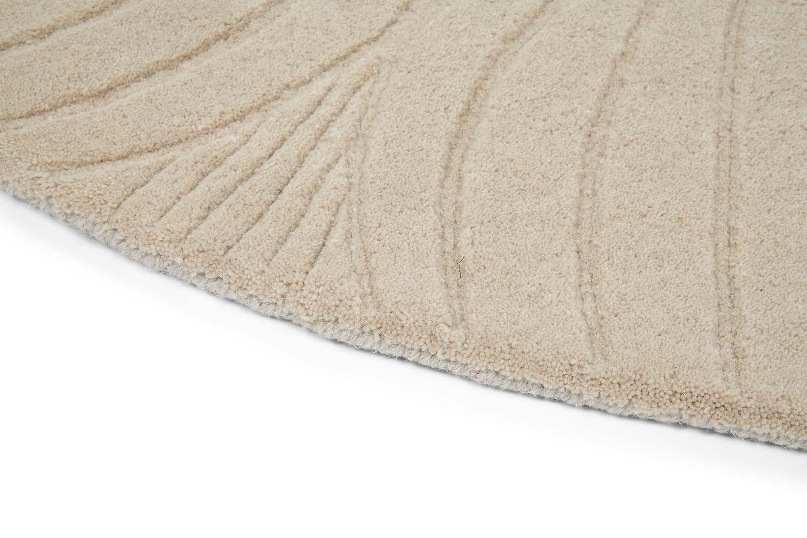 Round beige rug with engraved floral botanical pattern