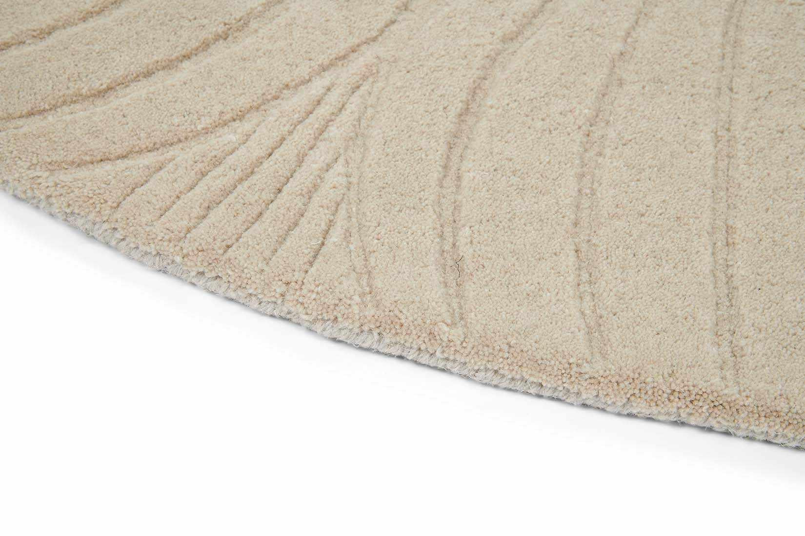 Round beige rug with engraved floral botanical pattern