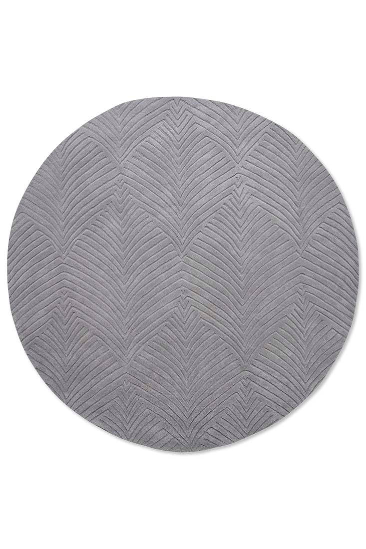 Circular grey rug with engraved leaf pattern

