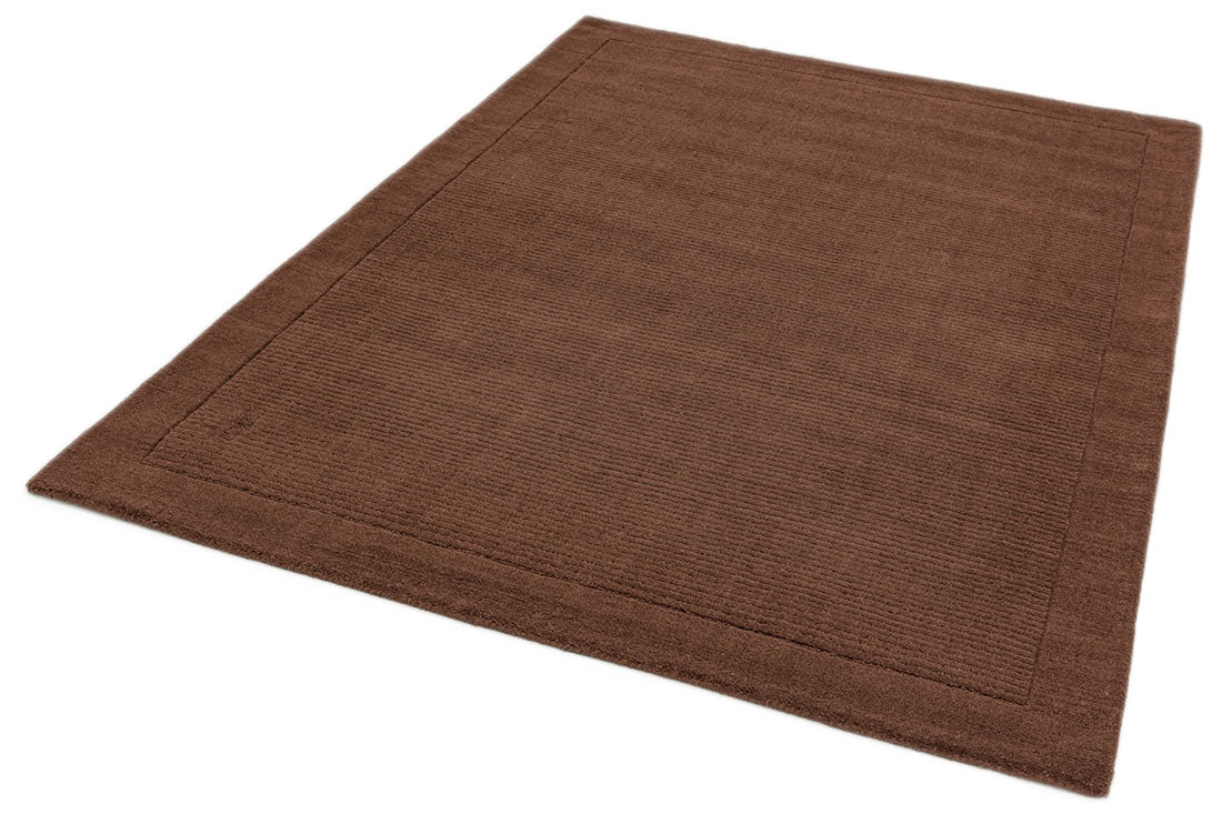 A plain brown rectangle-shaped wool rug with thin border.