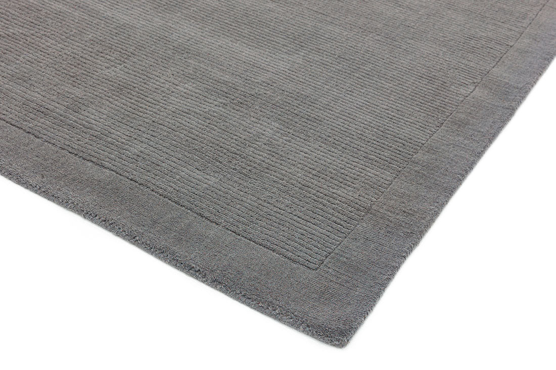 A plain grey rectangle-shaped wool rug with thin border.