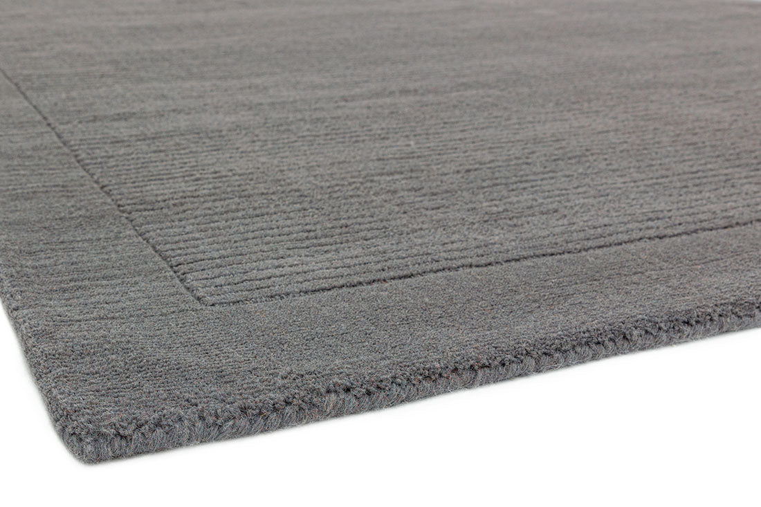 A plain grey rectangle-shaped wool rug with thin border.