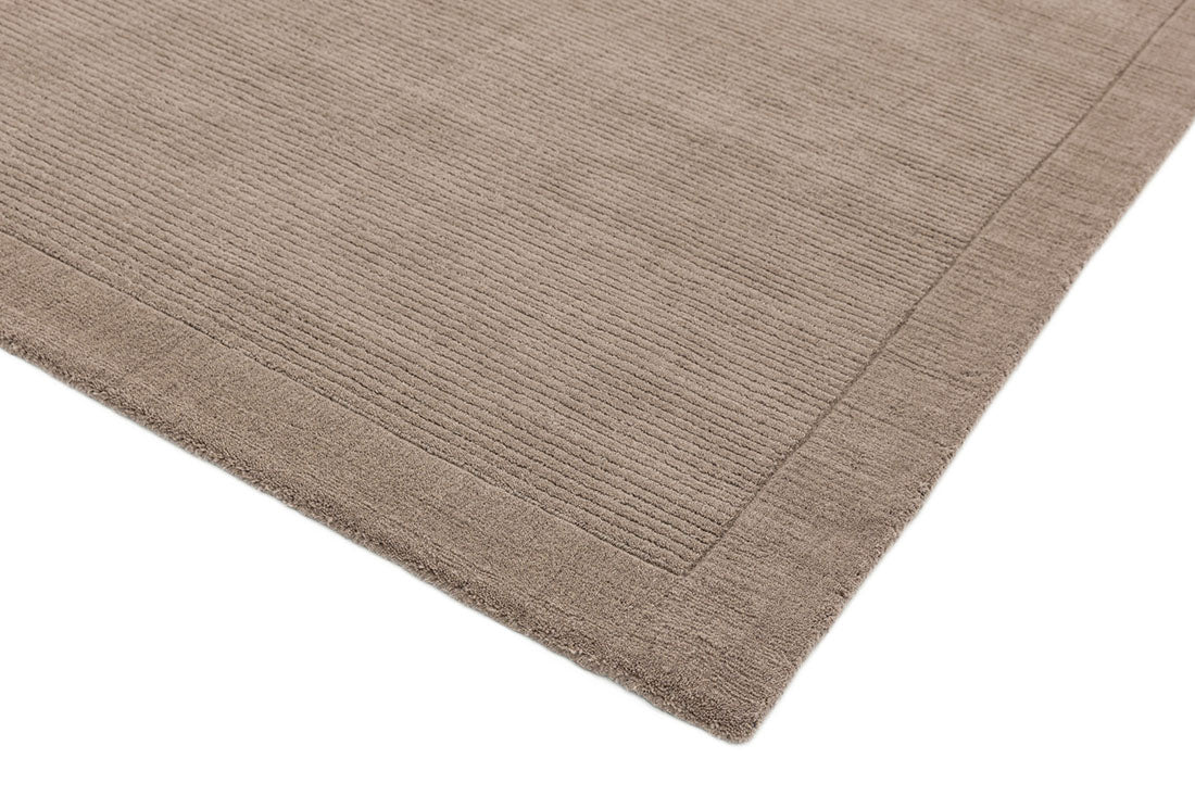 A taupe brown rectangle-shaped wool rug with thin border.