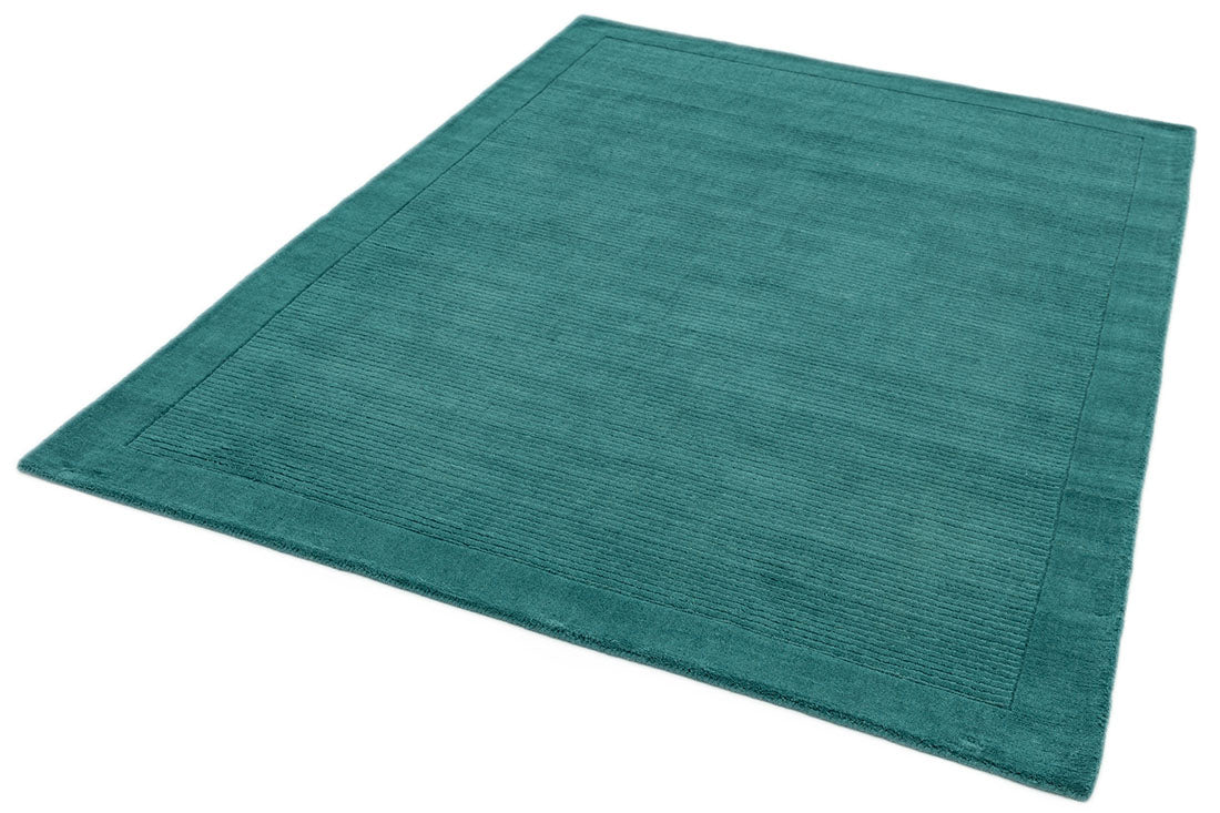 A teal blue rectangle-shaped wool rug with thin border.