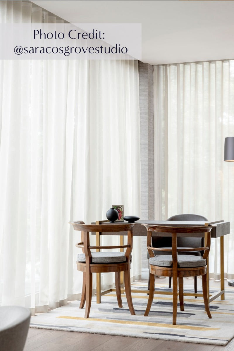 Rectangular white wool rug with pink, yellow, purple and green flowers and leaves