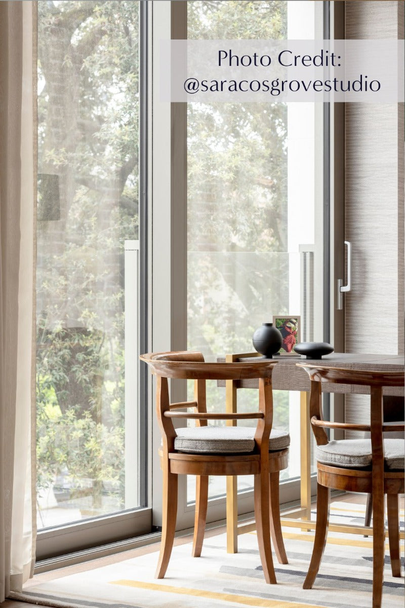 Rectangular white wool rug with pink, yellow, purple and green flowers and leaves