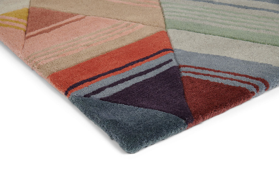 Harlequin rug with a multi-directional stripe design in red