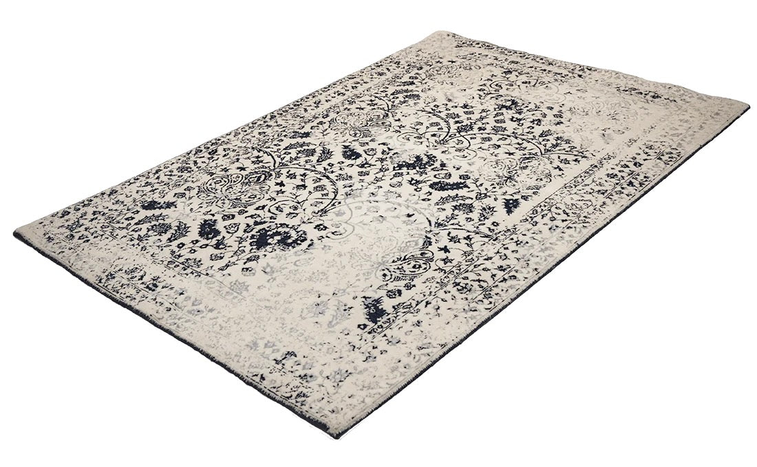 cream and blue oriental rug with a floral design